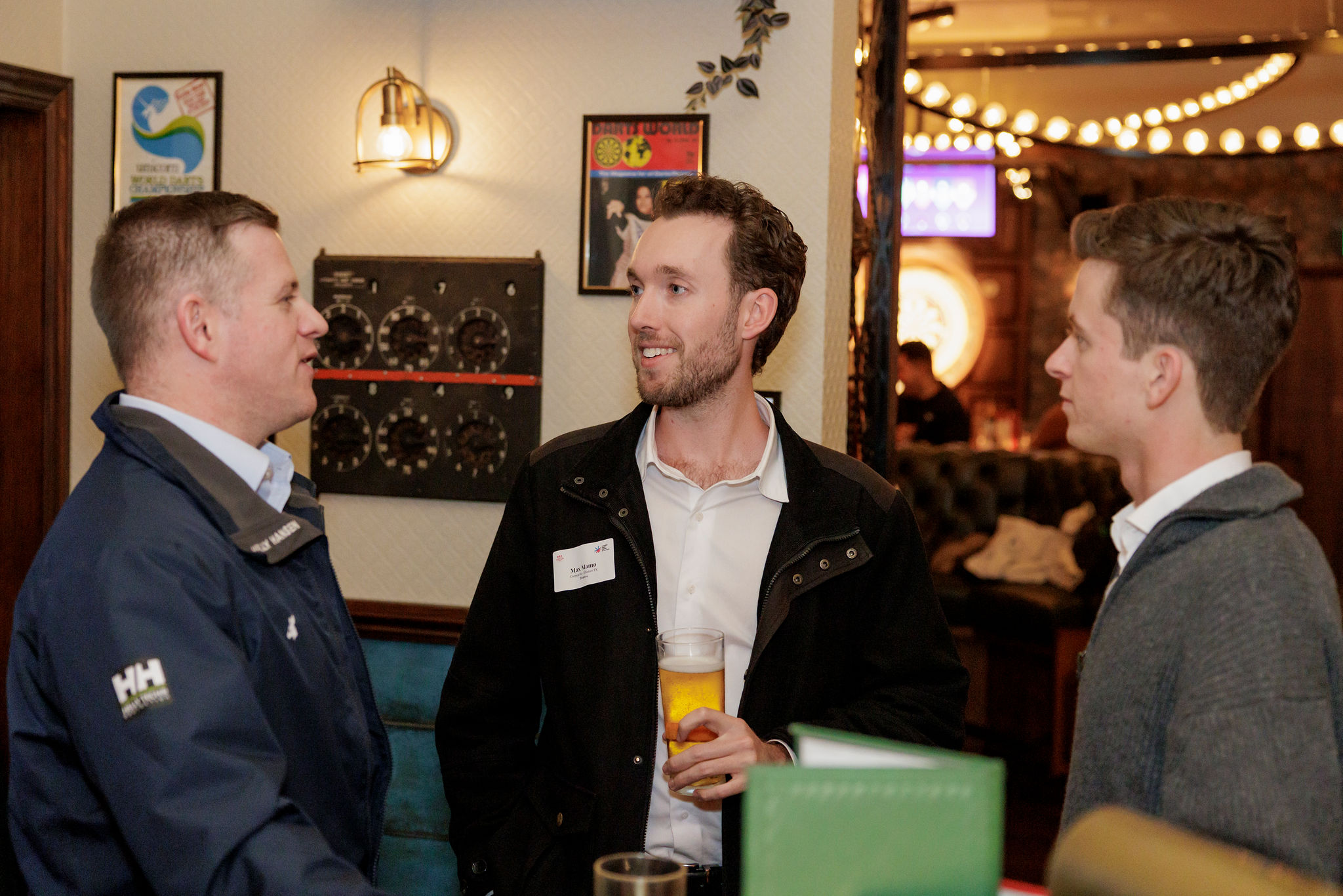 Delta Tango Advisory team speaking with ABCC attendees during Bullseyes & Business Cards